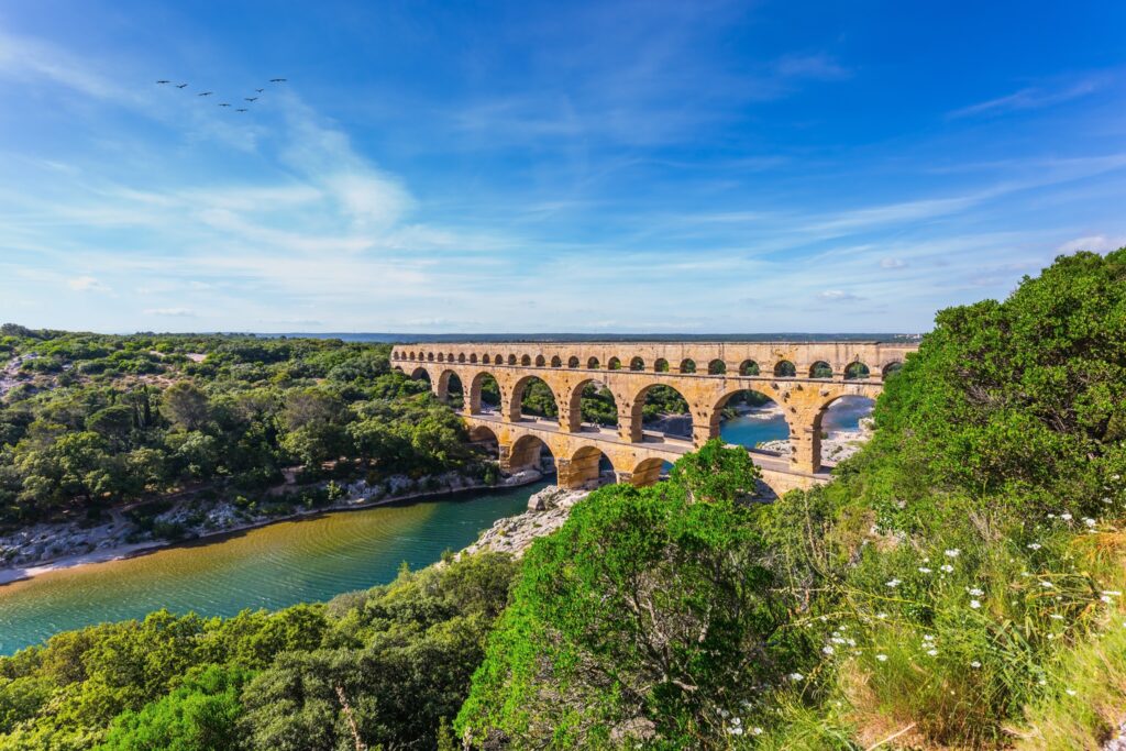 The Pont du Gard in Southern France is a classic example of Roman architecture. Still standing two millenia later, it shows the skills of the engineers, but if you look up close you will be doubly amazed as the whole aqueduct only drops minimally along its 30 miles bringing water to nearby Nimes.