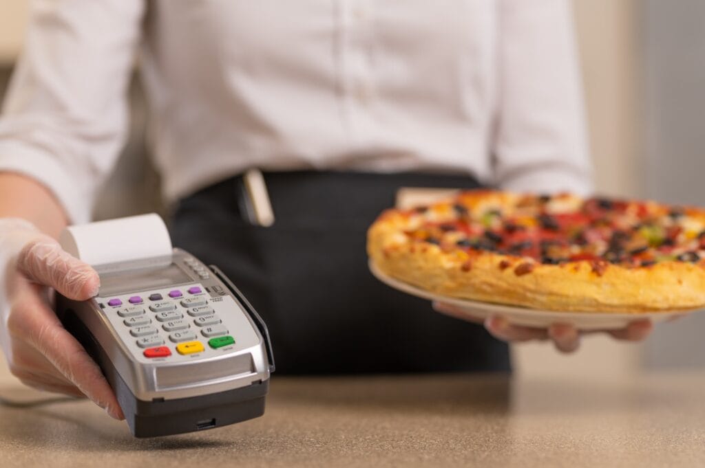 Paying with cards in Italy for pizza. Paying by card often gets you the best exchange rates when traveling in Italy.